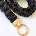 Load image into Gallery viewer, Black scrunchie keychain with gold clasp on a white background
