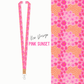 Floral patterned lanyard with 'Pink Sunset' design on a white background