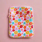 Floral patterned pouch on a pink background