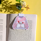 Sweater design with skull and roses on a book page with yellow background