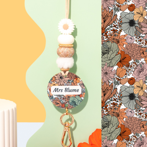 Floral keychain with 'Mrs Blume' text on a colorful background