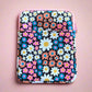 Floral patterned pouch on a pink background