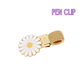 Gold pen clip with a daisy design on a white background