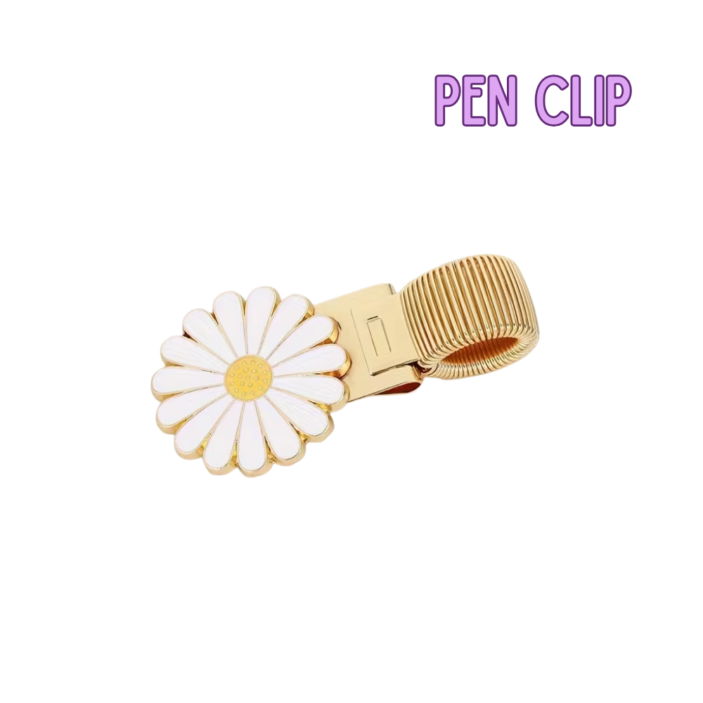 Gold pen clip with a daisy design on a white background