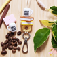 The Lilly Jayne Collective Coffee Teach Repeat Teacher Lanyard features a keychain with mini coffee mug charms, sunflowers, and stacked books—perfect for teachers who love coffee. The mugs read coffee teach repeat.