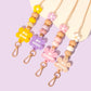 Collection of all 4 Flower personalised lanyards from the Blooms and Beads Collection. Yellow, Pink, purple and Beige options.
