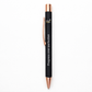 Black pen with rose gold accents and 'Progress over perfection' text on a white background