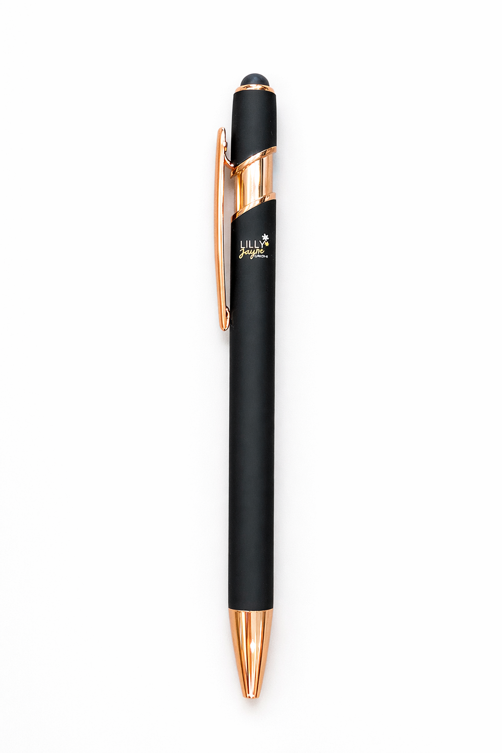Black pen with rose gold accents on a white background