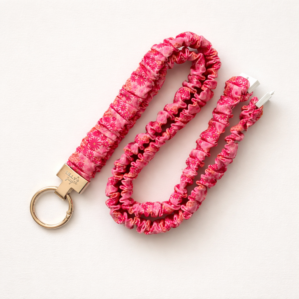 Pink scrunchie keychain and lanyard on a white background