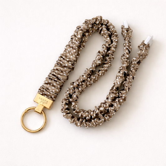 Textured keychain with gold ring and visible brand name on a white background