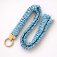 Load image into Gallery viewer, Blue floral-patterned keychain with gold ring on a white background
