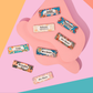 Colorful name badges with floral designs on a pink background