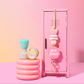 A pink personalized lanyard with a floral pattern and the name 'Miss Jenny' printed on it, displayed on a pink mini locker. alongside a pair of round pink earrings and a blue and yellow whistle.