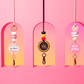 Three decorative keychains with names on a pink background