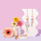 Decorative items with flowers and a keychain on a pink and purple gradient background