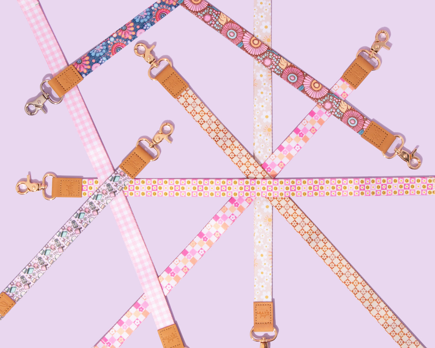 Set of colorful bag straps with floral and geometric patterns on a light purple background