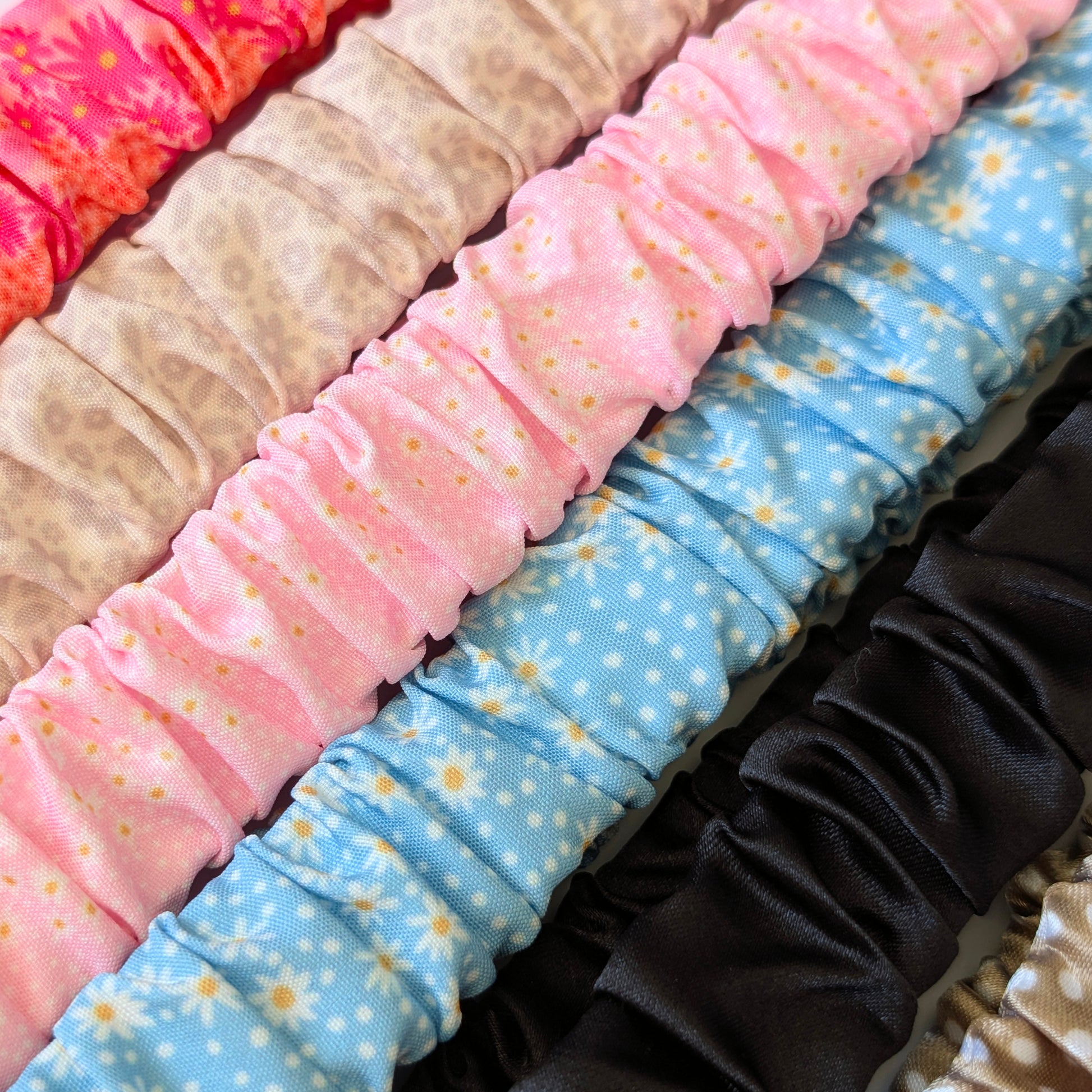 Stack of colorful scrunchies with various patterns
