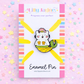 Enamel pin with a cat mermaid design on a colorful background with 'Lilly Jayne' branding.