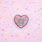 Heart-shaped 'Positive Vibes Only' pin on a pink background with stars