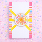 Colorful badge with 'Focus on the Good' text on a pink background with stars