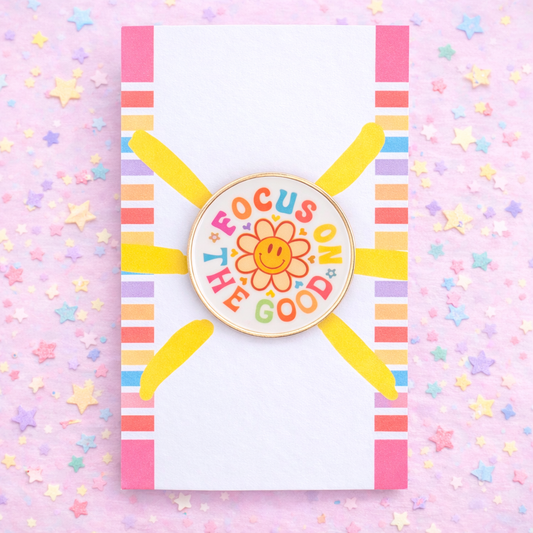 Colorful badge with 'Focus on the Good' text on a pink background with stars