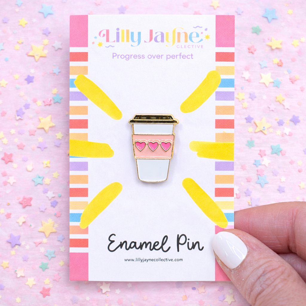 Enamel pin with a coffee cup design on a colorful card with 'Lilly Jayne Collective' branding.