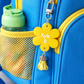 Blue backpack with yellow flower-shaped name tag and water bottle