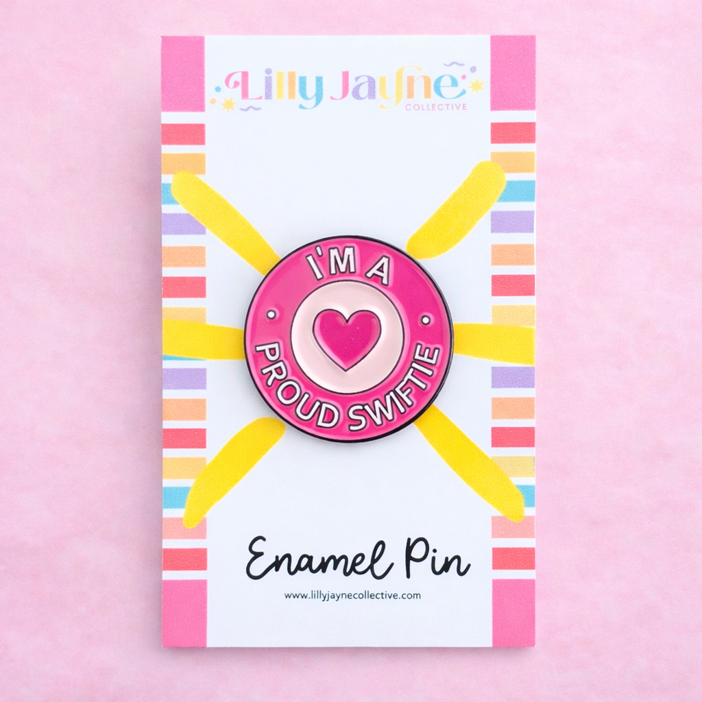 Enamel pin with heart design on a colorful card with 'Lilly Jayne Collective' branding.