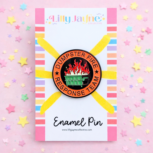 Enamel pin with 'Dumpster Fire Response Team' design on a colorful card with stars.
