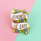 Pin with 'Kindness is Easy' text on a two-tone pink and green background