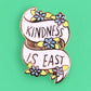 Pin with 'Kindness is Easy' text on a green background