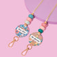 Colorful name badge holders with beads on a pink background