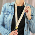 Load image into Gallery viewer, Person wearing a denim jacket holding a beige dog leash with a gold ring.
