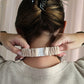 Person wearing a textured headband with a neutral background
