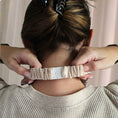 Load image into Gallery viewer, Person wearing a textured headband with a neutral background
