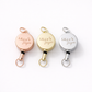 Three retractable keychains with 'LILLY JAYNE' engraving on a white background