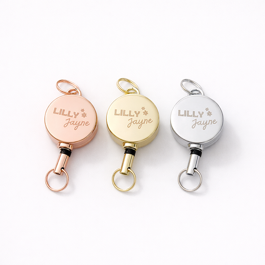 Three retractable keychains with 'LILLY JAYNE' engraving on a white background