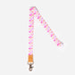 A colorful geometric patterned lanyard with a faux leather trim, silver clasp, and breakaway safety clasp.