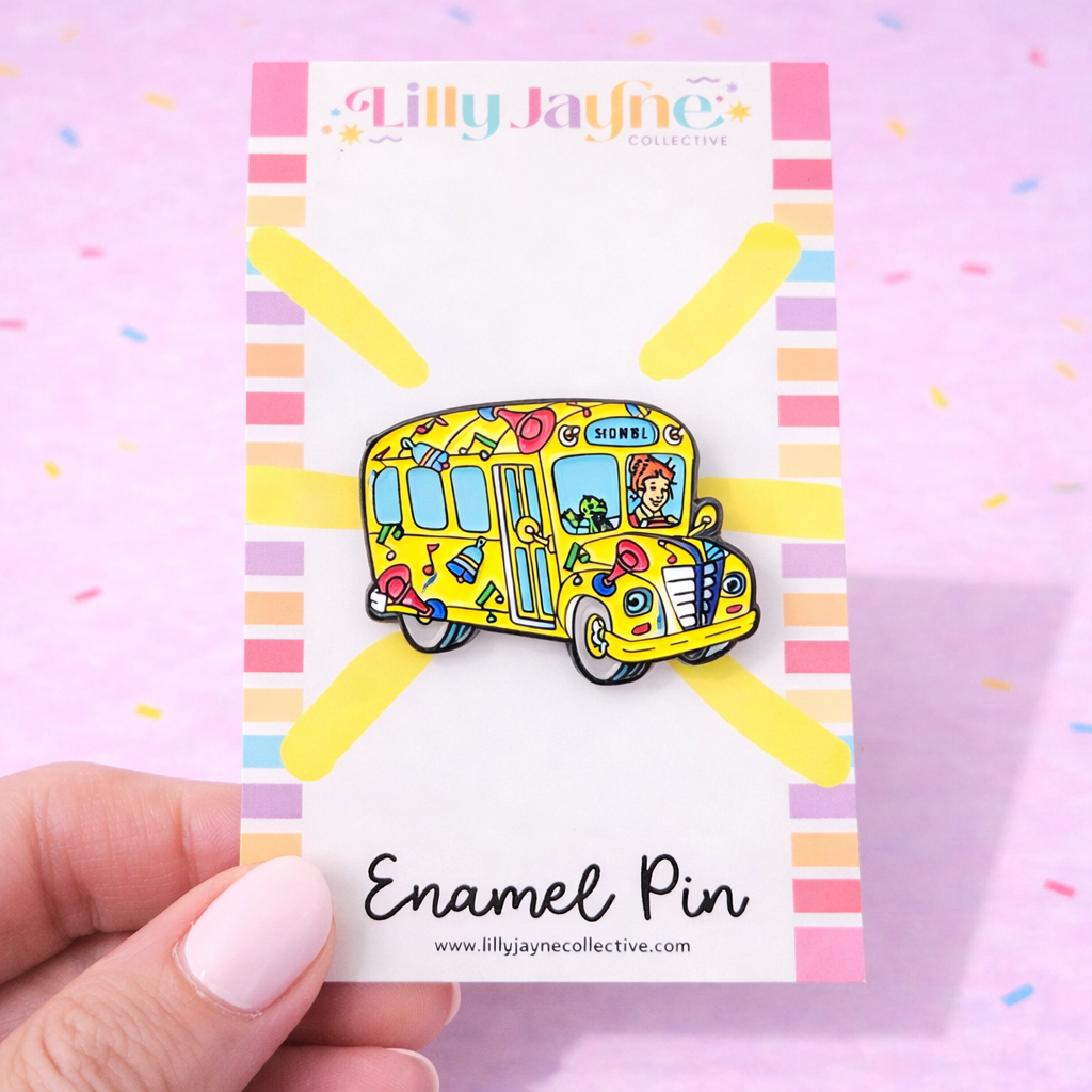 Colorful school bus enamel pin on a card with 'Lilly Jayne Collective' branding.