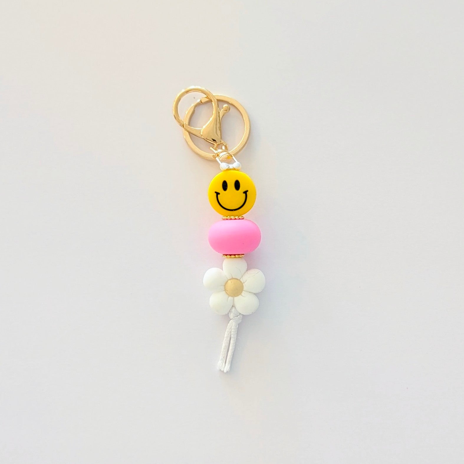 Yellow Smiley face keyring with gold clip and pink and white beads 